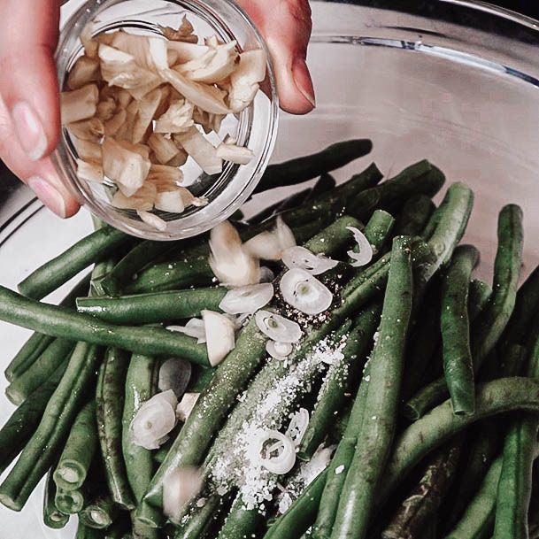 Adding Garlic To Lemon Roasted Green Beans With Walnut Recipe