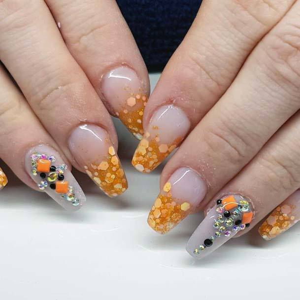 Adorned Transparent Orange Hued Summer Nail Art