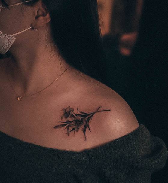 Aesthetic Lily Tattoo On Woman Collar Bone Shoulder