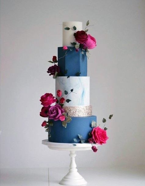 Alternating Blue And White Wedding Cakes With Red Roses