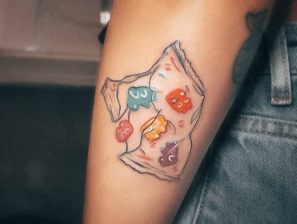 Artistic Gummy Bear Tattoo On Woman Torn Bag Forearm