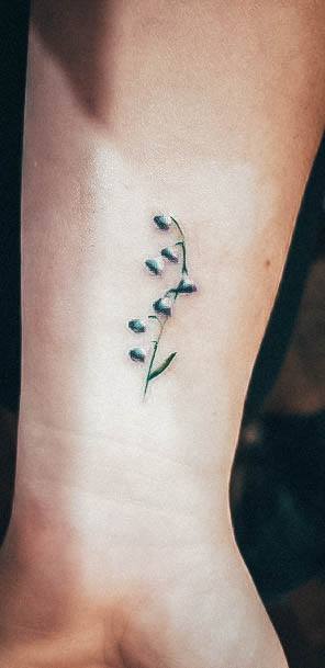 Artistic Lily Of The Valley Tattoo On Woman