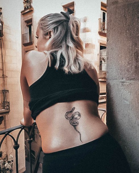 Artistic Lower Back Tattoo On Woman