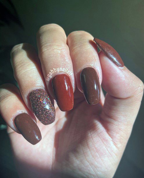 Artistic Maroon Glitter Nail On Woman