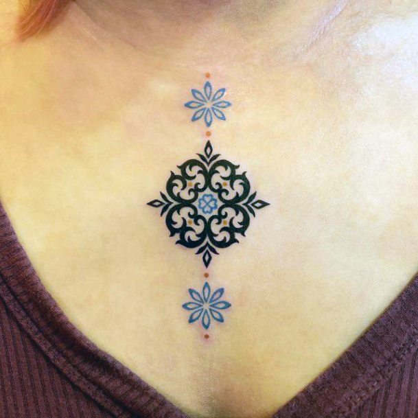 Artistic Ornamental Tattoo On Woman Chest Blue And Black Ink