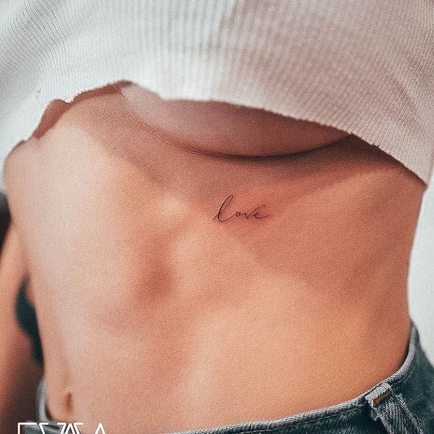 Artistic Small Chest Tattoo On Woman