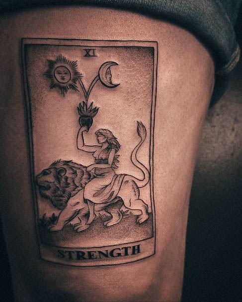 Artistic Strength Tattoo On Woman Thigh Tarot Cards