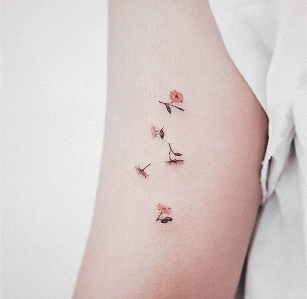 Artistic Tiny Tattoo On Woman Falling Flowers Arm