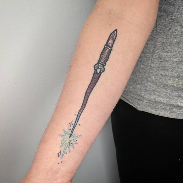 Artistic Wand Tattoo On Woman