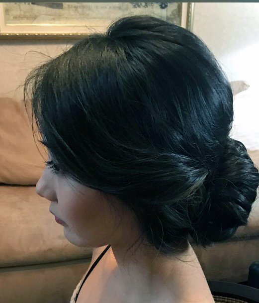Beautiful Glossy Dark Haired Side Bun Event Perfect Womens Hairstyle