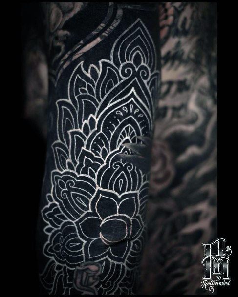 Black Backdrop And White Ink Floral Tattoo Women