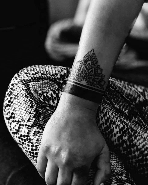 Black Band And Middle Eastern Art Work Tattoo On Wrist Women