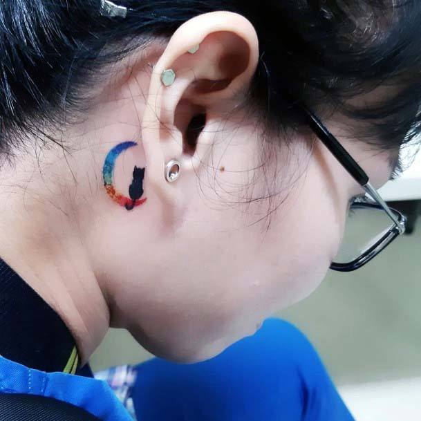 Black Kitty On Rainbow Moon Tattoo Behind The Ear