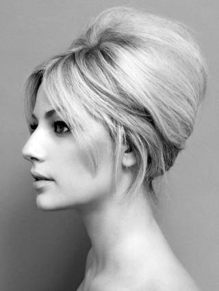 Blonde Woman With Sexy Low Profile Beehive Hairstyle And Bangs