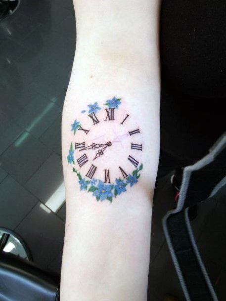 Blue Flowers And Roman Clock Tattoo Womens Arms