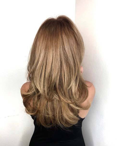 Bombshell Brown And Blonde Highlighted Polished Blow Out Hairstyles For Women