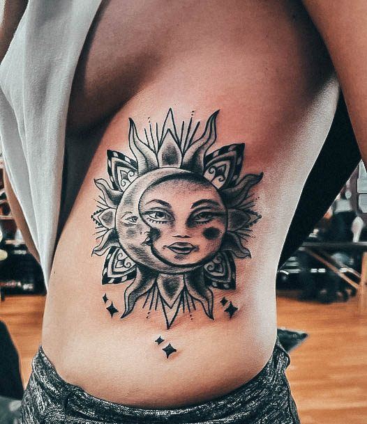 Breathtaking Sun And Moon Tattoo On Girl Rib Cage Side