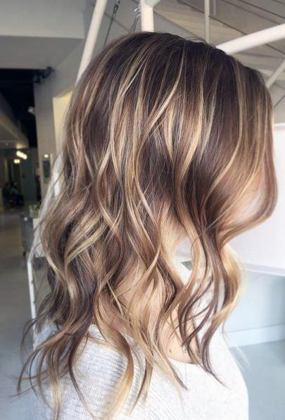 Brown And Blonde Highlighted Hottest Layered Wavy Womens Hairstyle Idea