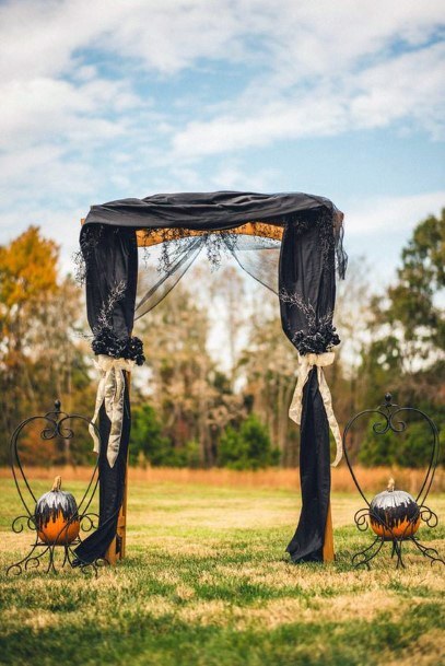 Captivating Fall Scenery Halloween Wedding Arch Black Curtain And Floral Orange Pumpkins For Newlyweds