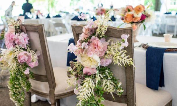 Chairs Decorated With Summer Wedding Flowers