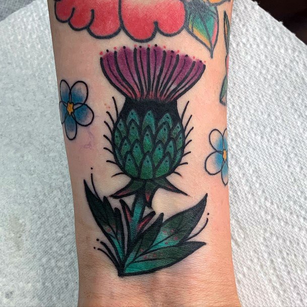 Cool Female Thistle Tattoo Designs