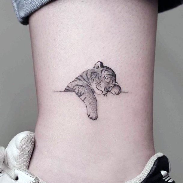 Cute Sleeping Lion Cub Tattoo For Women