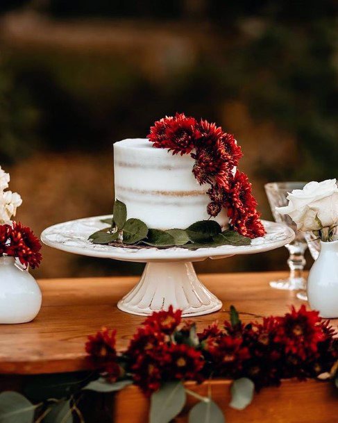 Dark Red Flowers On Rustic Wedding Cake