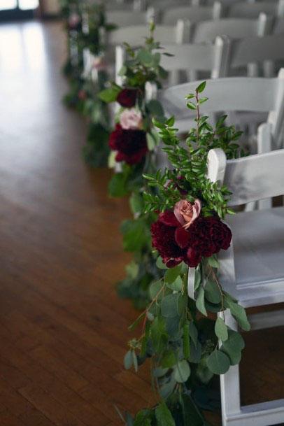 Decorated Chair With Burgundy Flowers And Greens