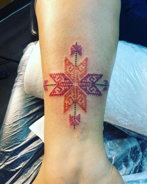 Decorative Cross Stitch Tattoo On Female