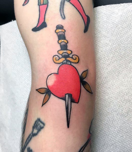 Decorative Dagger Heart Tattoo On Female