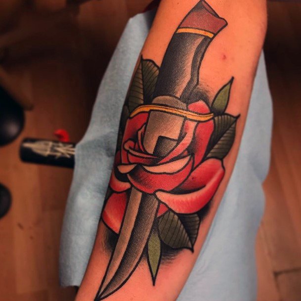 Decorative Dagger Rose Tattoo On Female