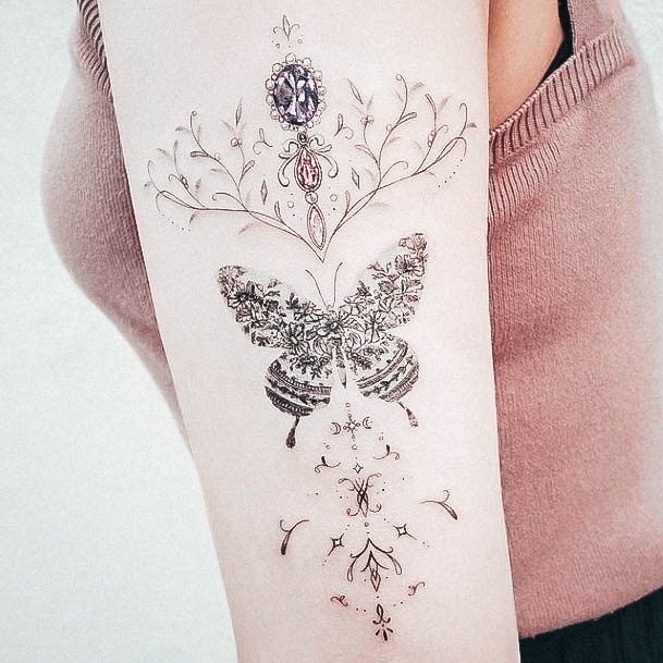 Decorative Gem Tattoo On Female Floral Butterfly Forearm