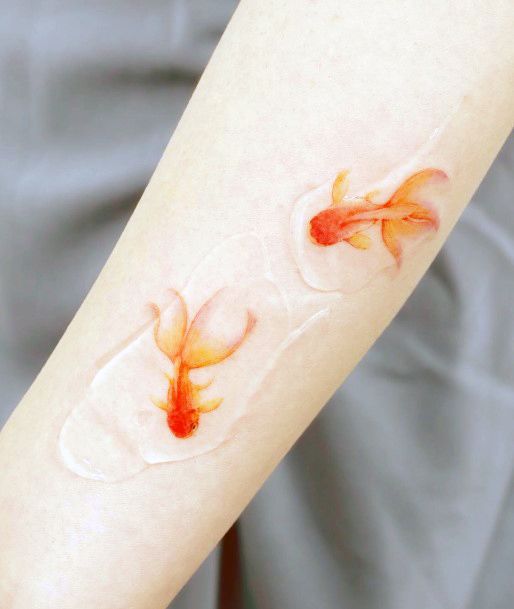 Decorative Goldfish Tattoo On Female