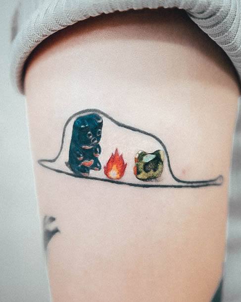 Decorative Gummy Bear Tattoo On Female With Campfire Theme