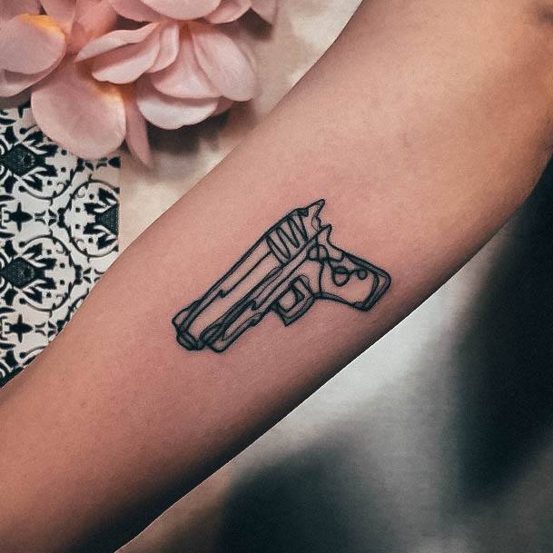 Decorative Gun Tattoo On Female