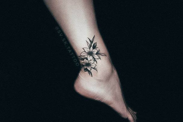 Decorative Lily Tattoo On Female Ankles