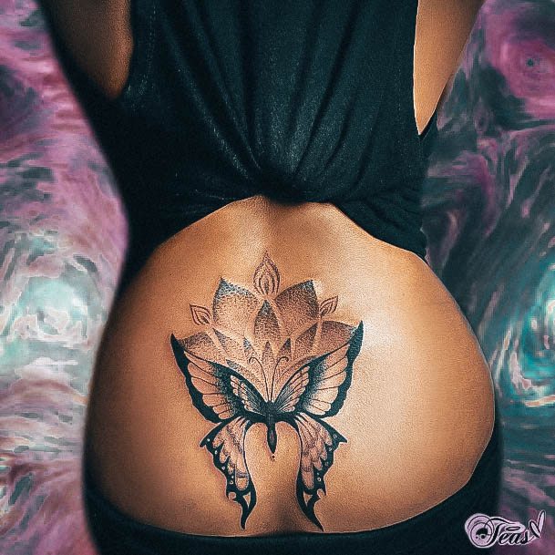 Decorative Lower Back Tattoo On Female