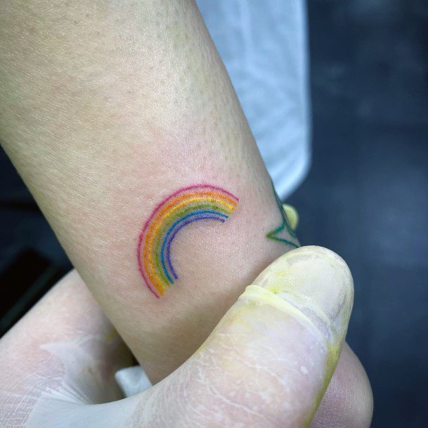 Decorative Rainbow Tattoo On Female