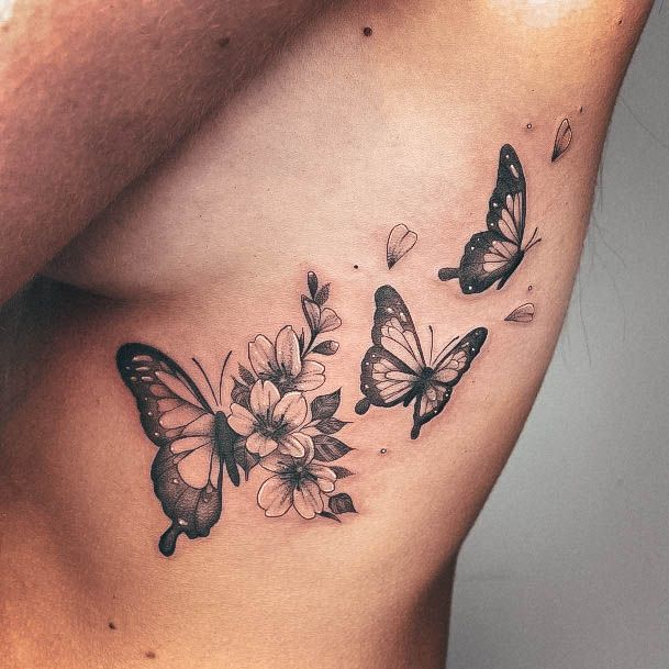 Decorative Rib Tattoo On Female Butteruyfly