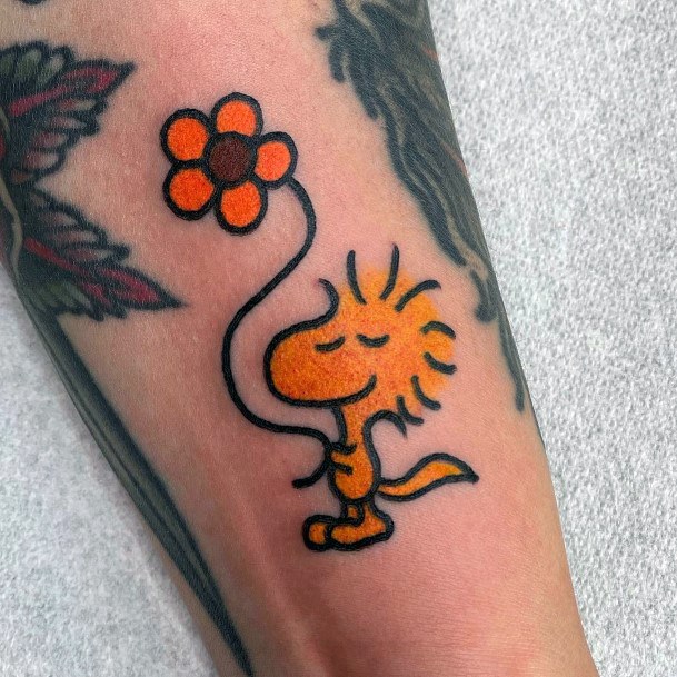 Decorative Snoopy Tattoo On Female