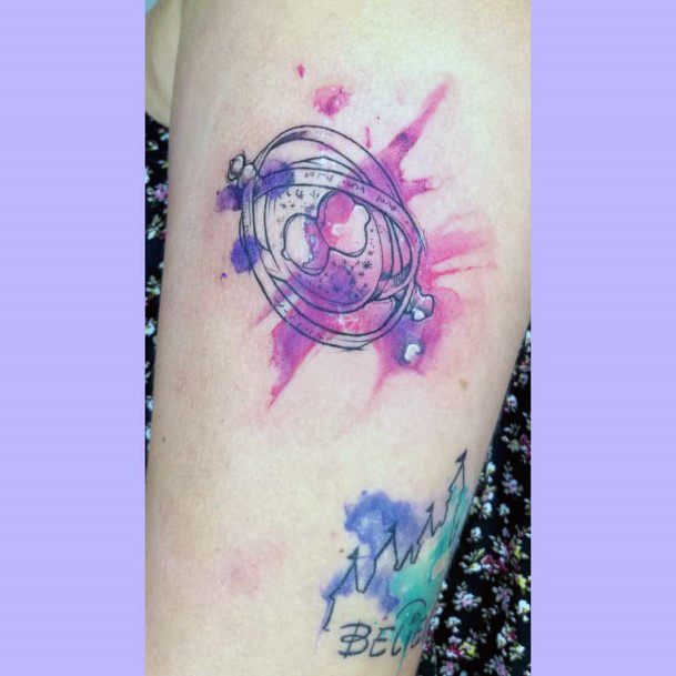 Decorative Time Turner Tattoo On Female