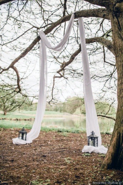 Elegant Drapery Over Large Tree Natural Wedding Arch Ideas