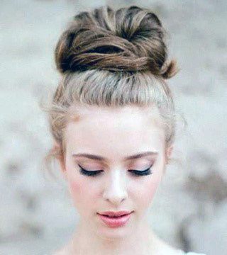 Enchanting Woman With Dirty Blonde Hair Teasing Top Knot Hairstyle