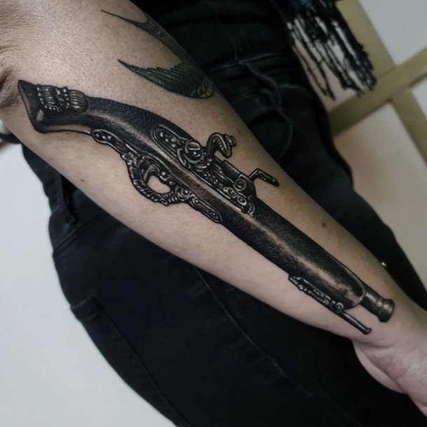 Exquisite Gun Tattoos On Girl Outer Forearm