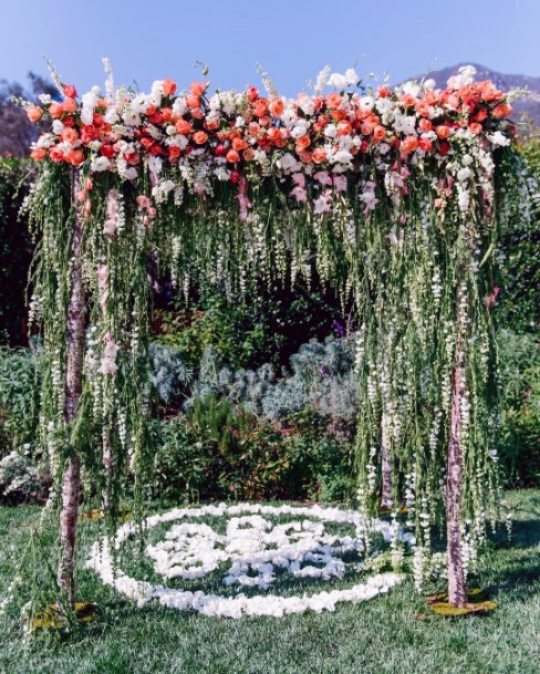 Fall Wedding Ideas Whimsical Orange And White Flowers With Hanging Greenery Wedding Arch