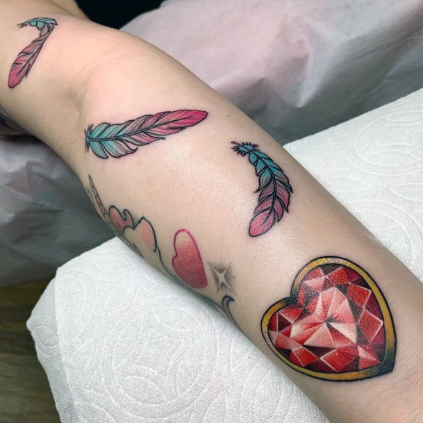 Feathers And Red Gem Tattoo For Women