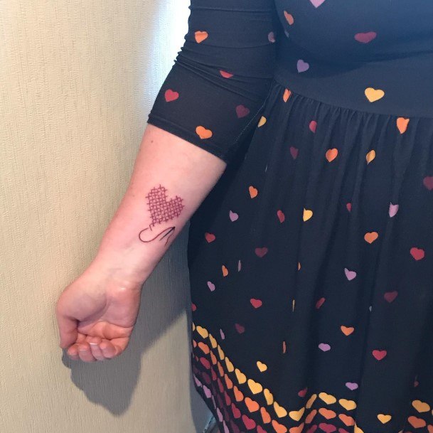 Female Cross Stitch Tattoo On Woman