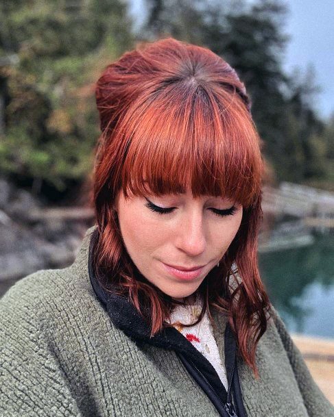 Female Deep Brown Bouffant With Golden Highlights And Center Bun