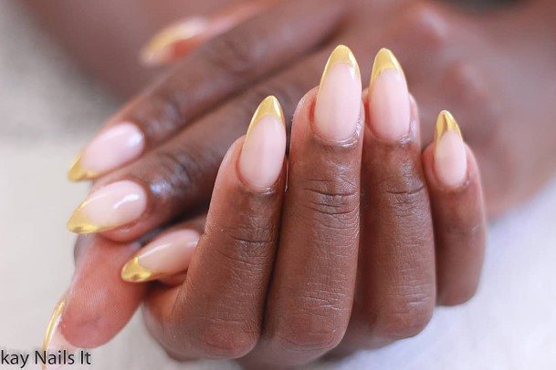 Female Gold French Tip Nails