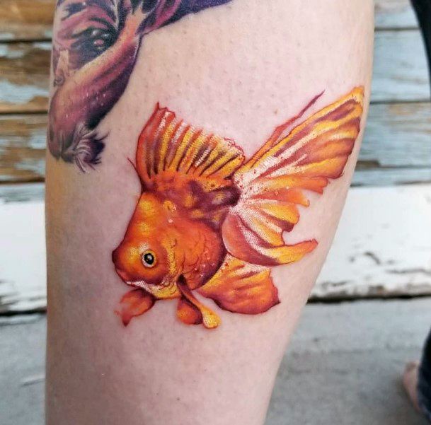 Female Goldfish Tattoo On Woman